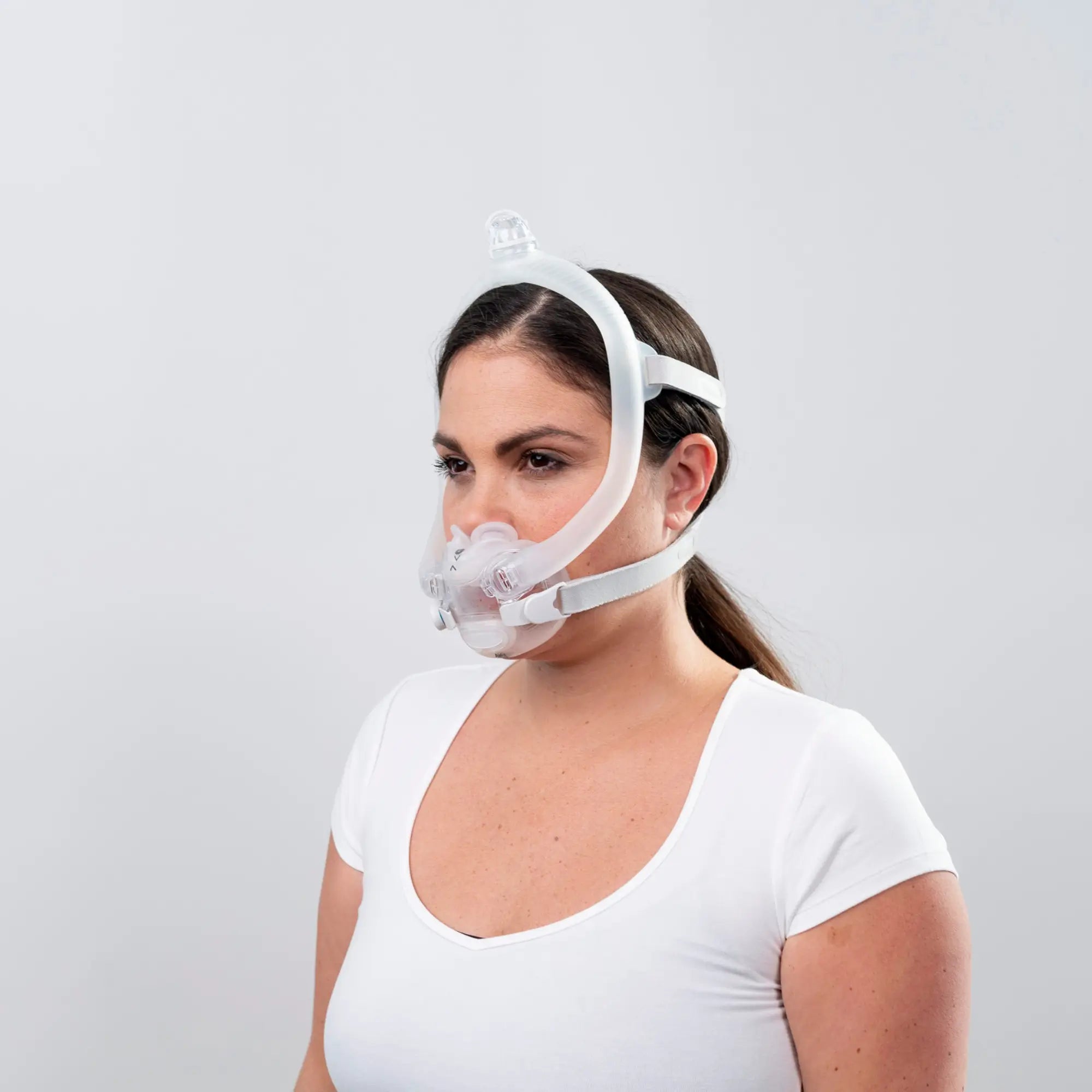 woman using the resmed airfit x30i oral nasal full face cpap mask side view