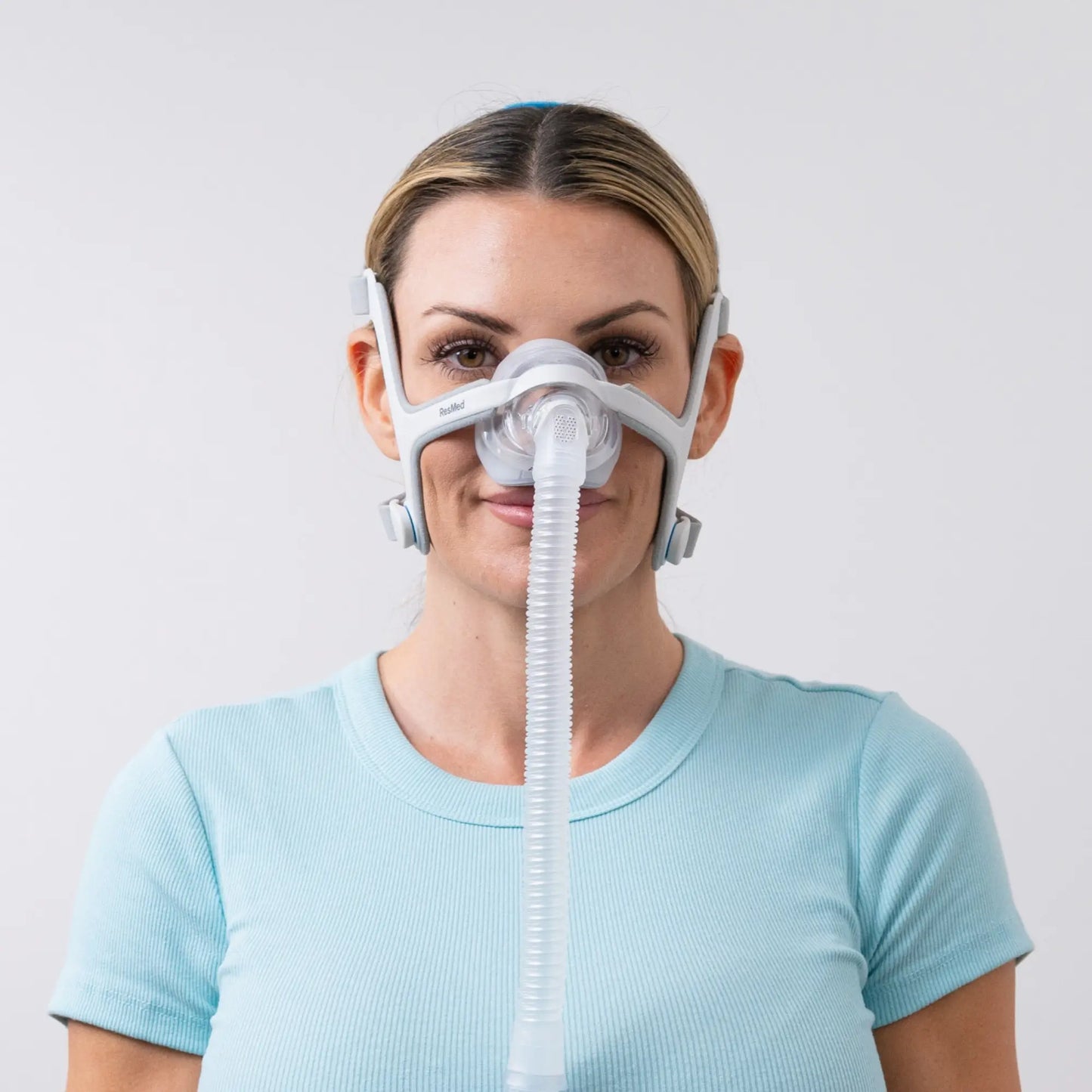 woman using the ResMed AirTouch N20 Nasal Mask front view