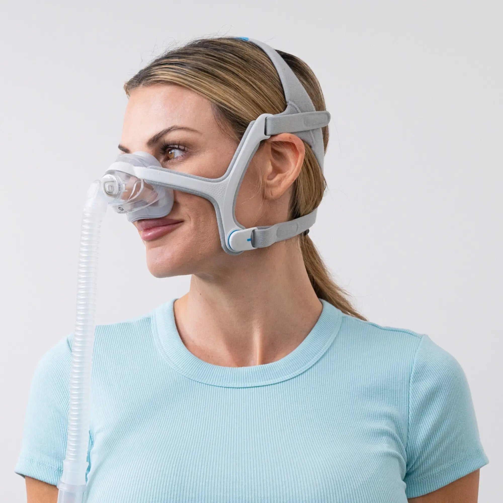 woman using the ResMed AirTouch N20 Nasal Mask side view