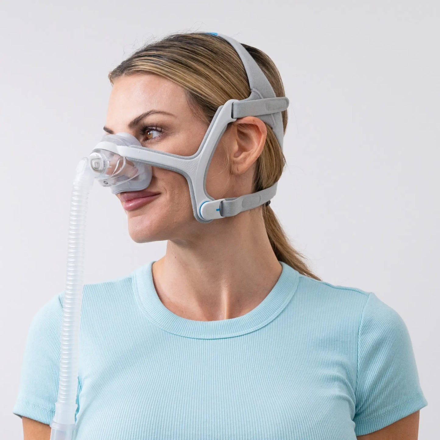 woman using the ResMed AirTouch N20 Nasal Mask side view