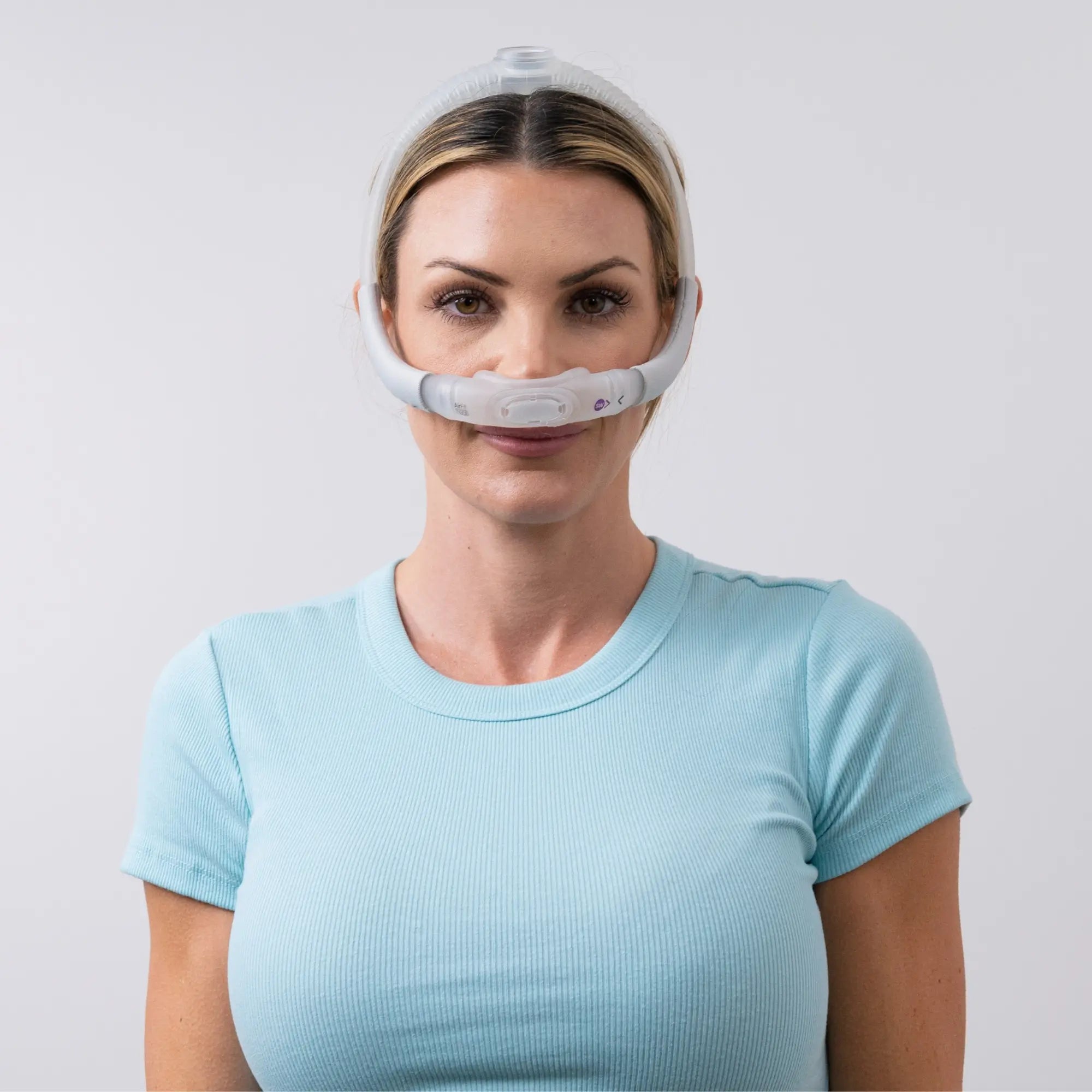 Woman using the ResMed AirTouch N30i Nasal CPAP Mask front view sleeplay copyright 