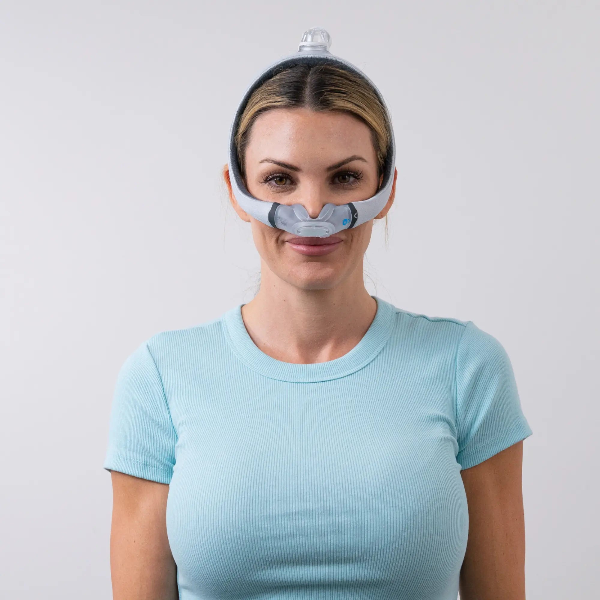 Woman using the ResMed AirTouch N30i Nasal CPAP Mask front view sleeplay copyright 