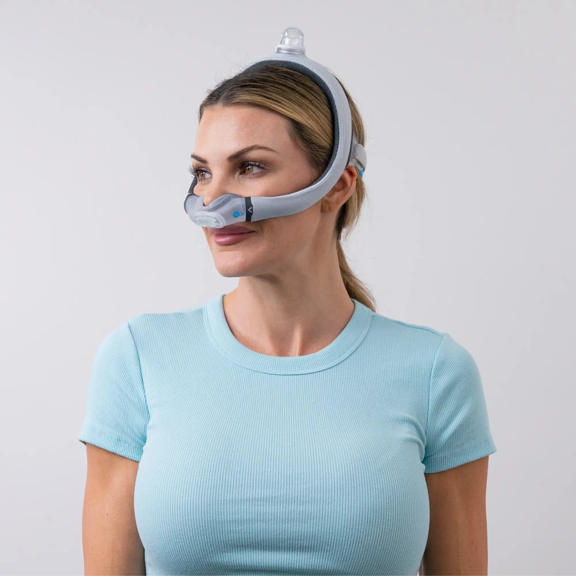 Woman using the ResMed AirTouch N30i Nasal CPAP Mask side view sleeplay copyright 