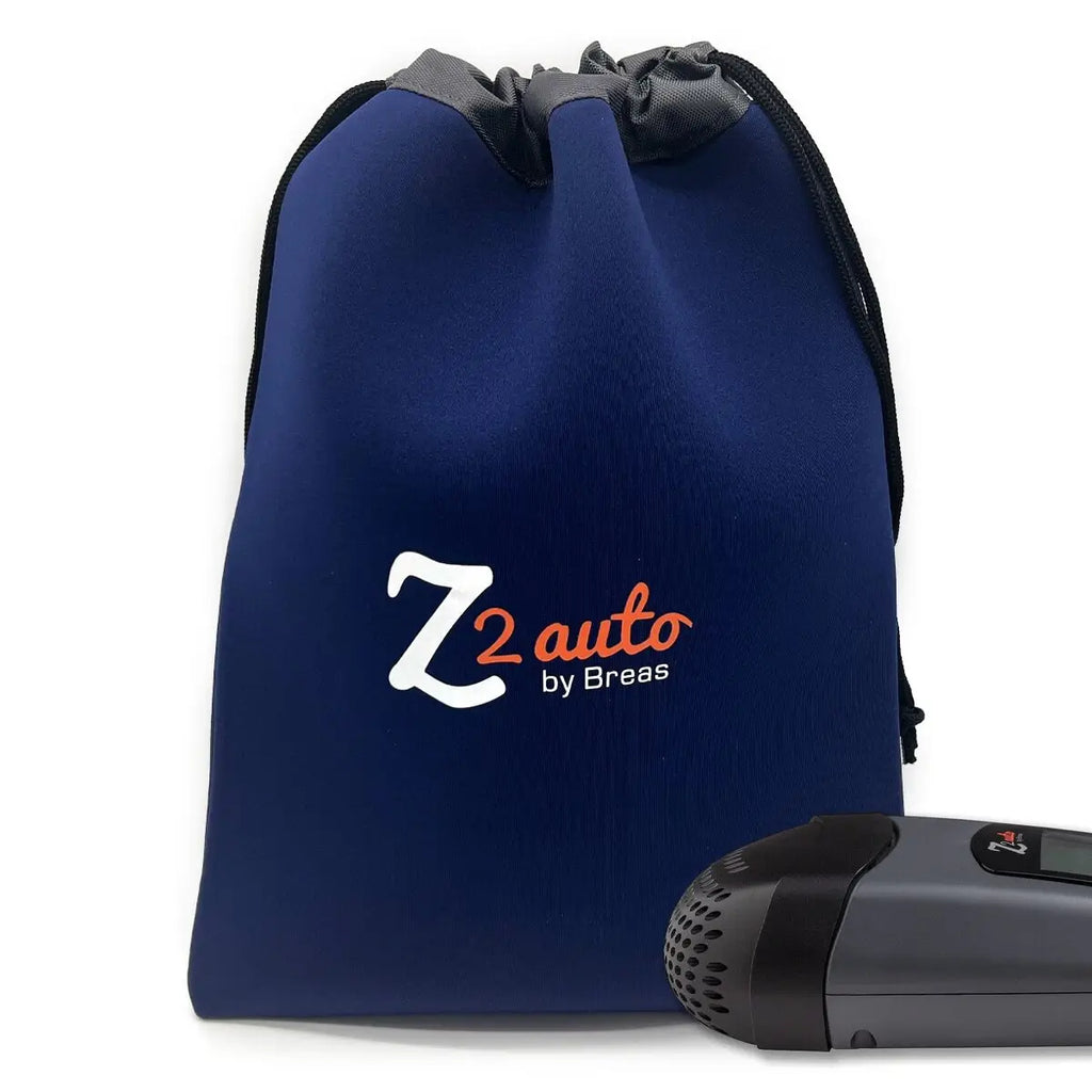Breas Z2 Auto navy drawstring travel bag with logo and travel CPAP machine beside it