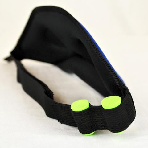 Side view of Blockout Shade Mask in blue color with green earplugs on the side.