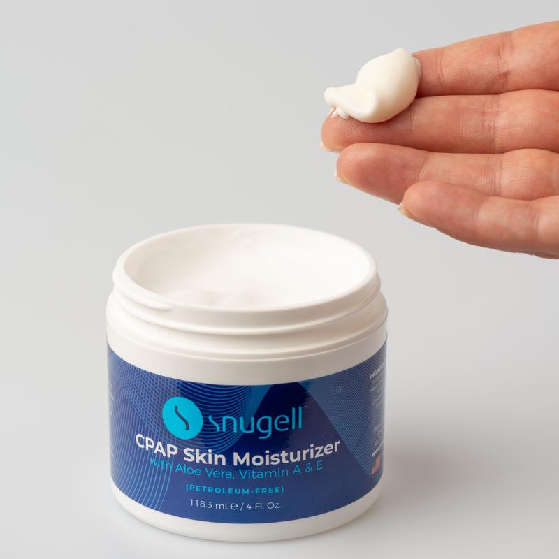 Closeup of Snugell CPAP Skin Moisturizer with model fngers
