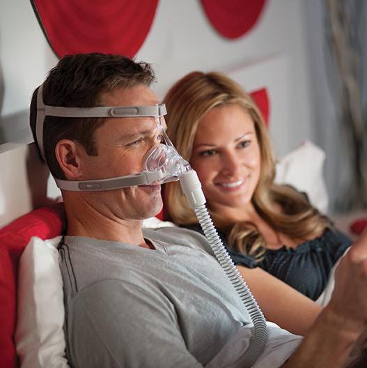 Man reading tablet while wearing the Nasal Pico Mask.