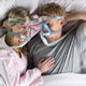 Couple laying in bed with both using the Amara Full Face CPAP Mask with Gel & Silicone Cushions