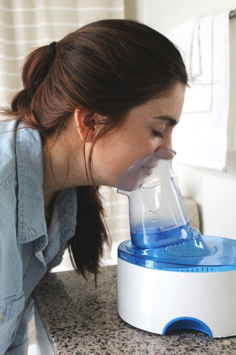 Woman using the inhaler.