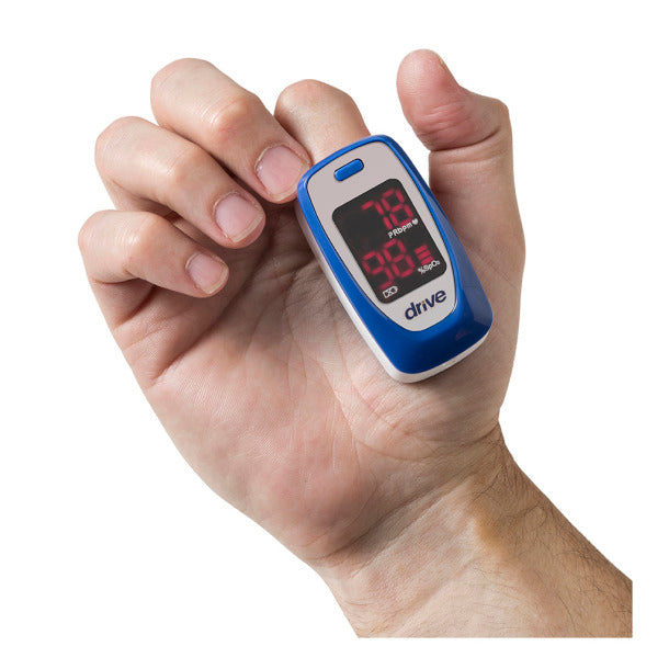 Drive finger tip pulse oximeter on hand in use