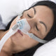 Woman sleeping with Brevida Nasal Pillow CPAP Mask