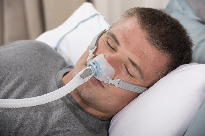 Man sleeping with Brevida Nasal Pillow CPAP Mask