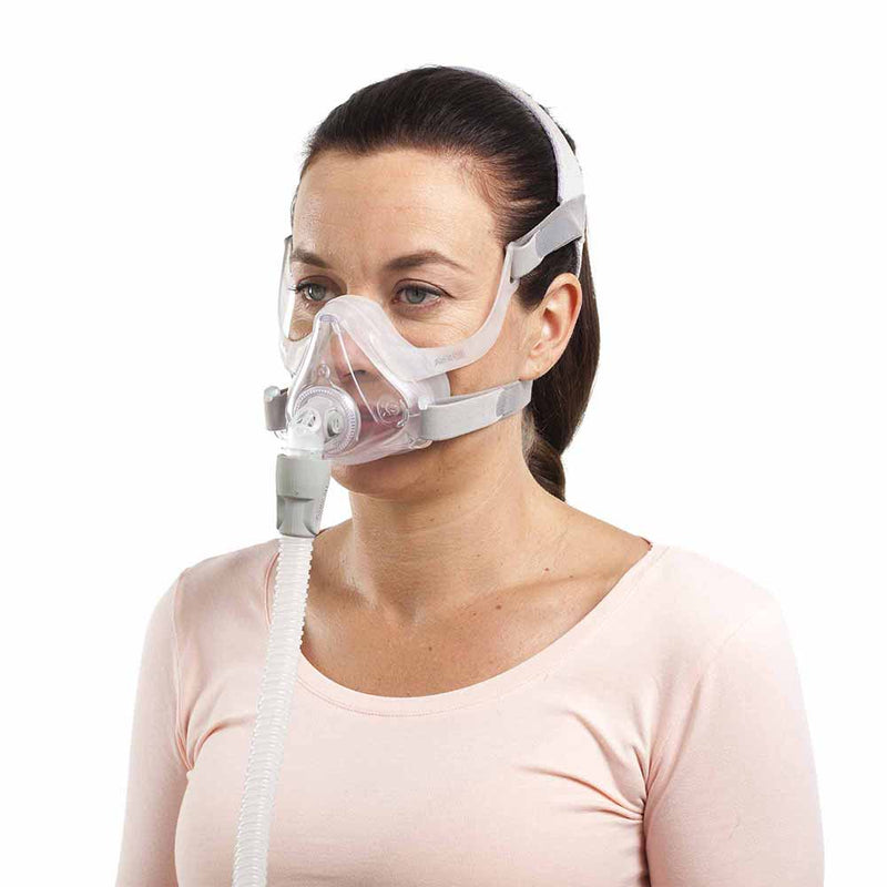 Woman using ResMed AirFit F10 Mask.