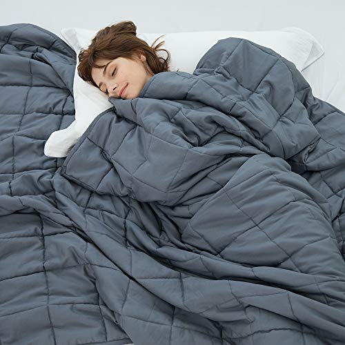 Woman sleeping in weighted blanket.