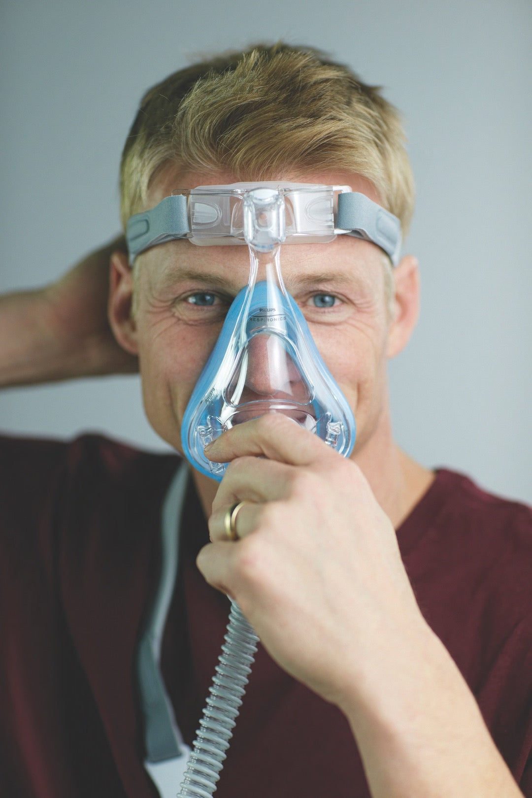 Man grabbing the Amara Full Face CPAP Mask with Gel & Silicone Cushions