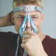 Man grabbing the Amara Full Face CPAP Mask with Gel & Silicone Cushions