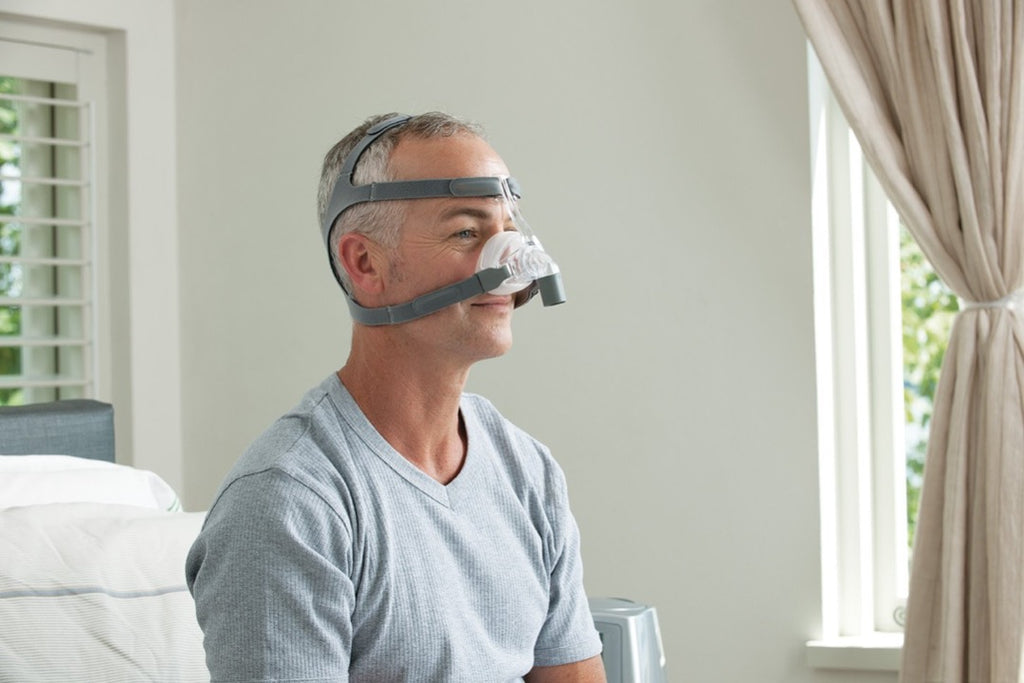 Man using the clear Eson Nasal Mask by Fisher and Paykel.