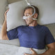 Man comfortably using DreamWisp Nasal Mask while sleeping.