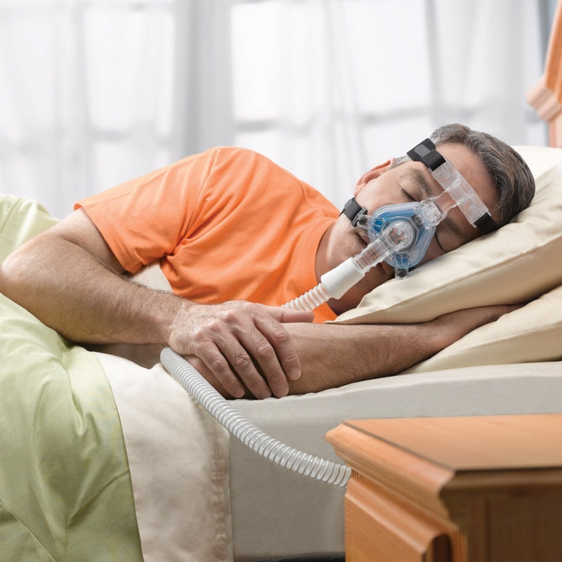 Side sleeper man with Phillips Respironics ComfortGel Blue Nasal Mask.