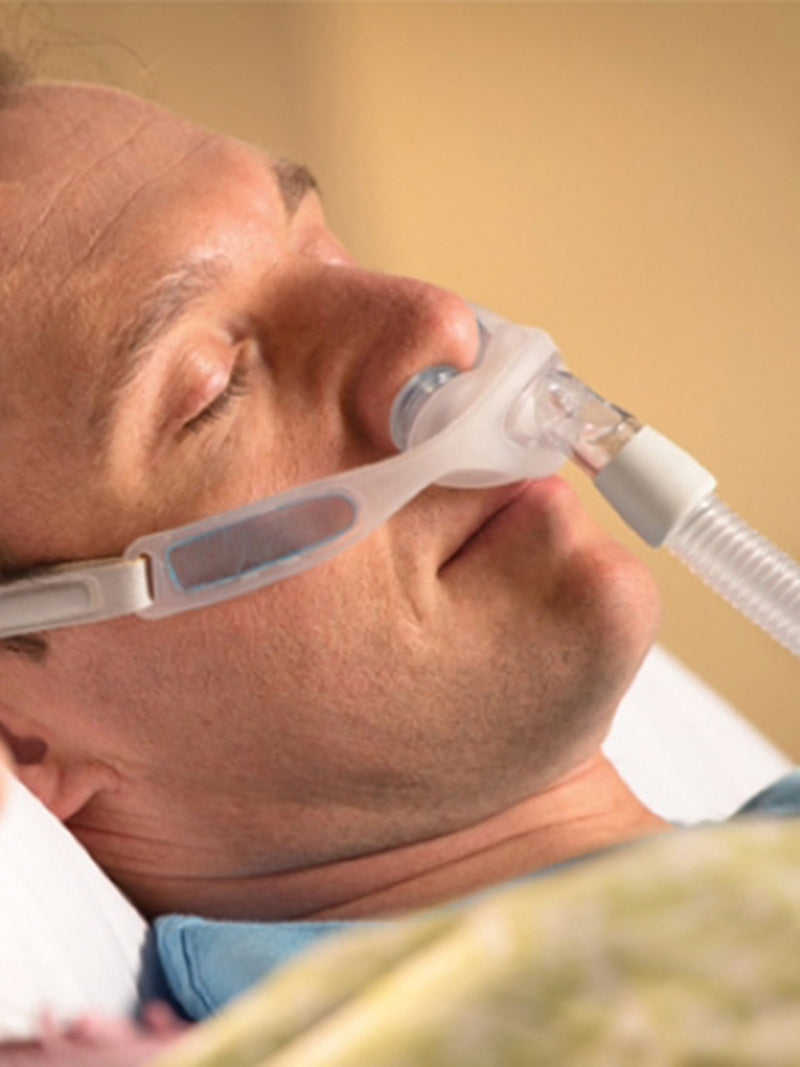 Man sleeping with Respironics Nuance Nasal Mask.