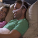 Man lying in bed wearing nasal mask from DreamWear Fit Pack by ResMed