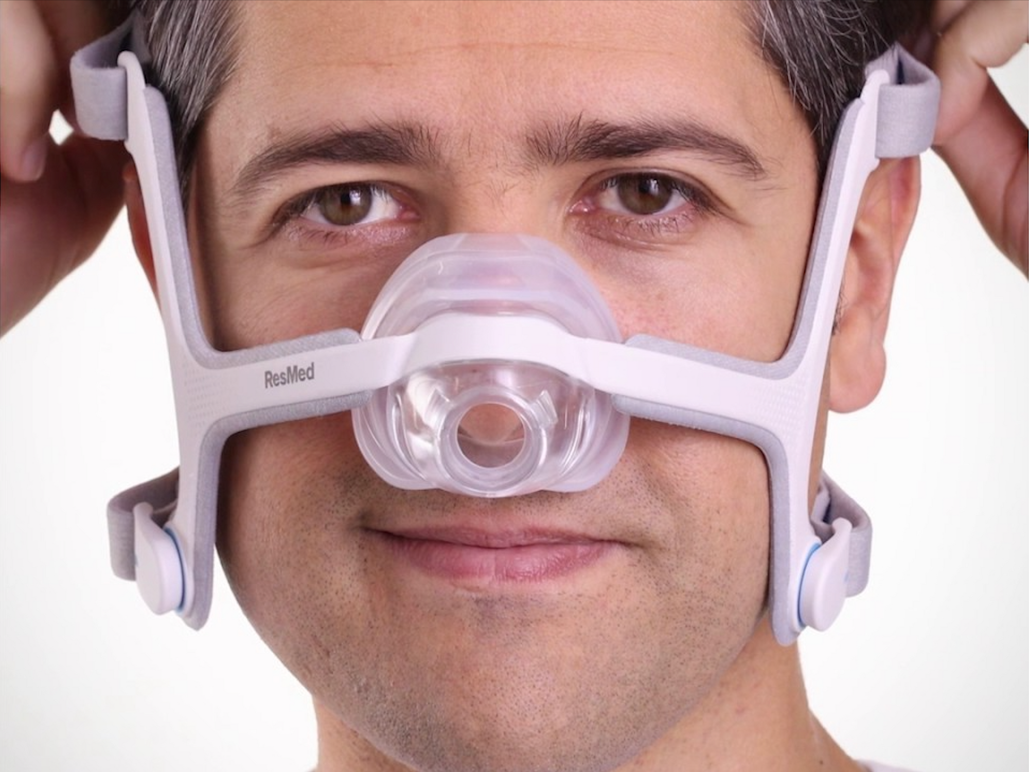 Man adjusting headgear of AirFit N20 Mask