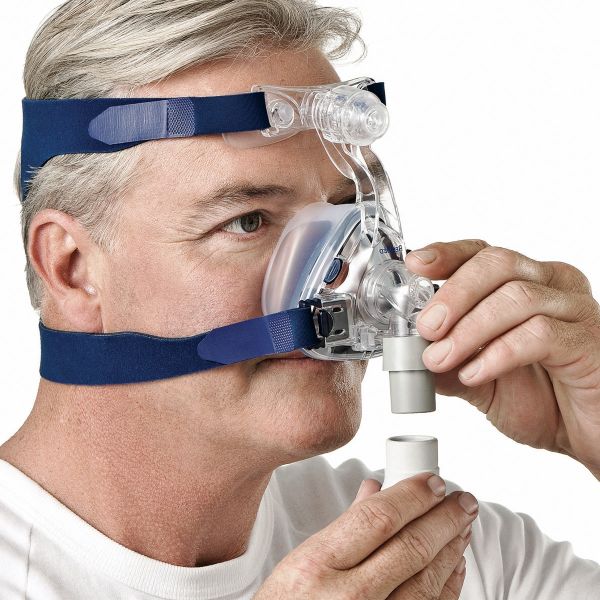 Man adjusting tube connection of Mirage SoftGel Nasal CPAP Mask with Headgear