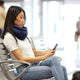 Woman Wearing Light Versatile Travel Pillow In Airport.