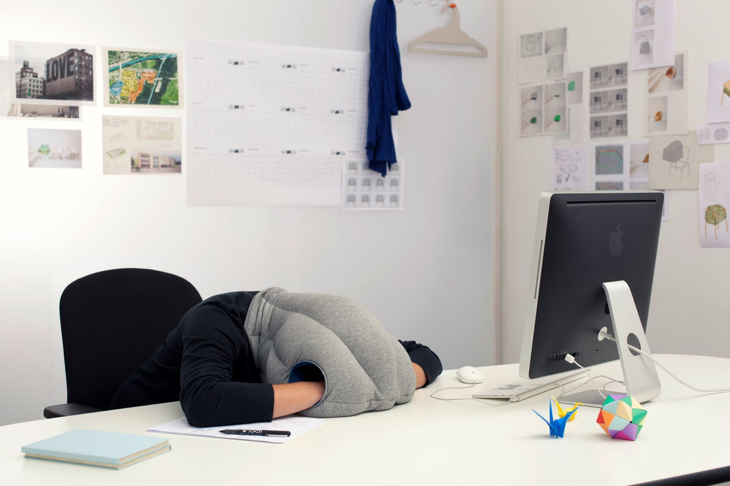 Woman Sleeping On Desk With Original Immersive Napping Pillow.