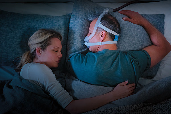 Man sleeping with the ResMed F30i Headgear