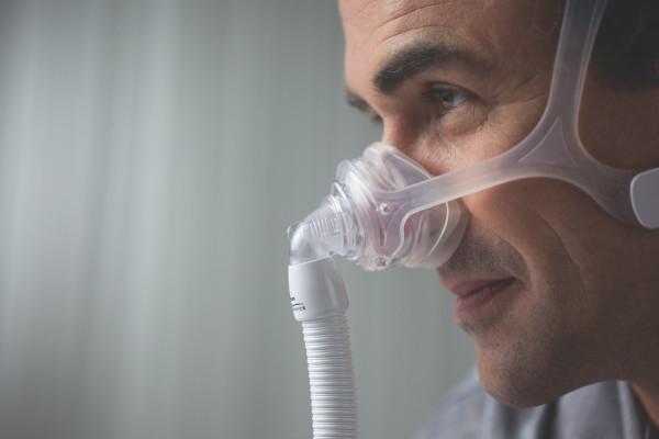 Side view of man wearing Frame for Respironics Wisp Nasal Mask