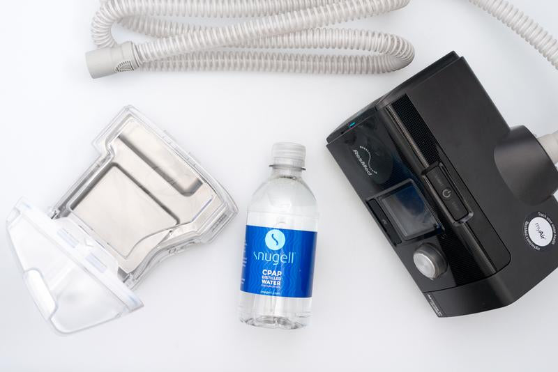 Snugell Bottle Next To Machine and Humidifier.