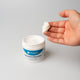 Front view of Snugell Daily Moisturizing Cream with model fingers