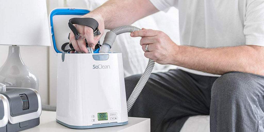 Man putting mask supplies in the SoClean Cleaner Machine for morning cleaning..