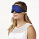 Woman using the green earplugs with the Blockout Shade Mask in blue color.