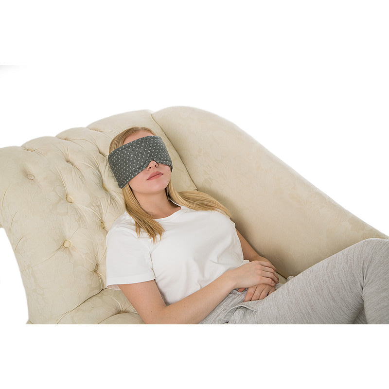 Woman laying down with sleep mask.