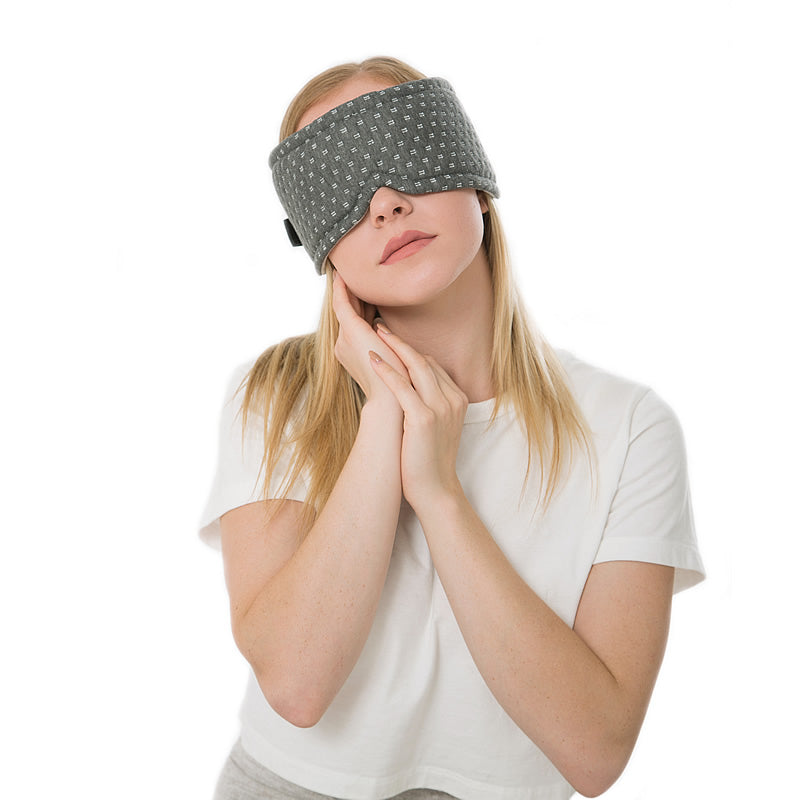 Woman wearing sleep mask.