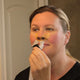 Woman putting on the Bleep Eclipse CPAP mask.