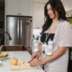 Woman cooking while using the Duo Double Electric Pump.