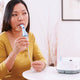 Woman using InnoSpire Essence Compressor Nebulizer