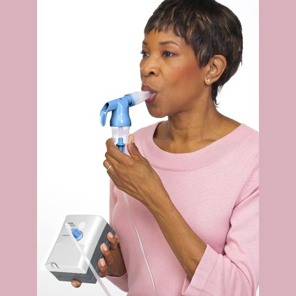 woman using the Innospire Mini with Portable Compressor Nebulizer