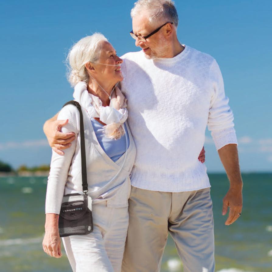 Couple On Beach Using Inogen One G5 Portable Oxygen Concentrator Bundle