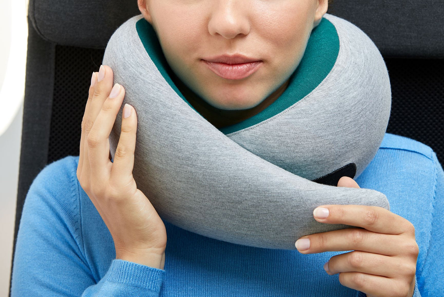 Woman Strapping On Neck Pillow.