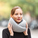 Woman On Street Wearing Midnight Grey Neck Pillow.