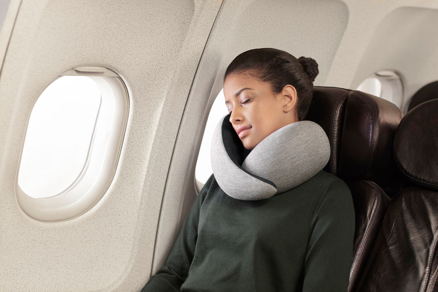 Woman Sleeping On Plane With Neck Pillow.