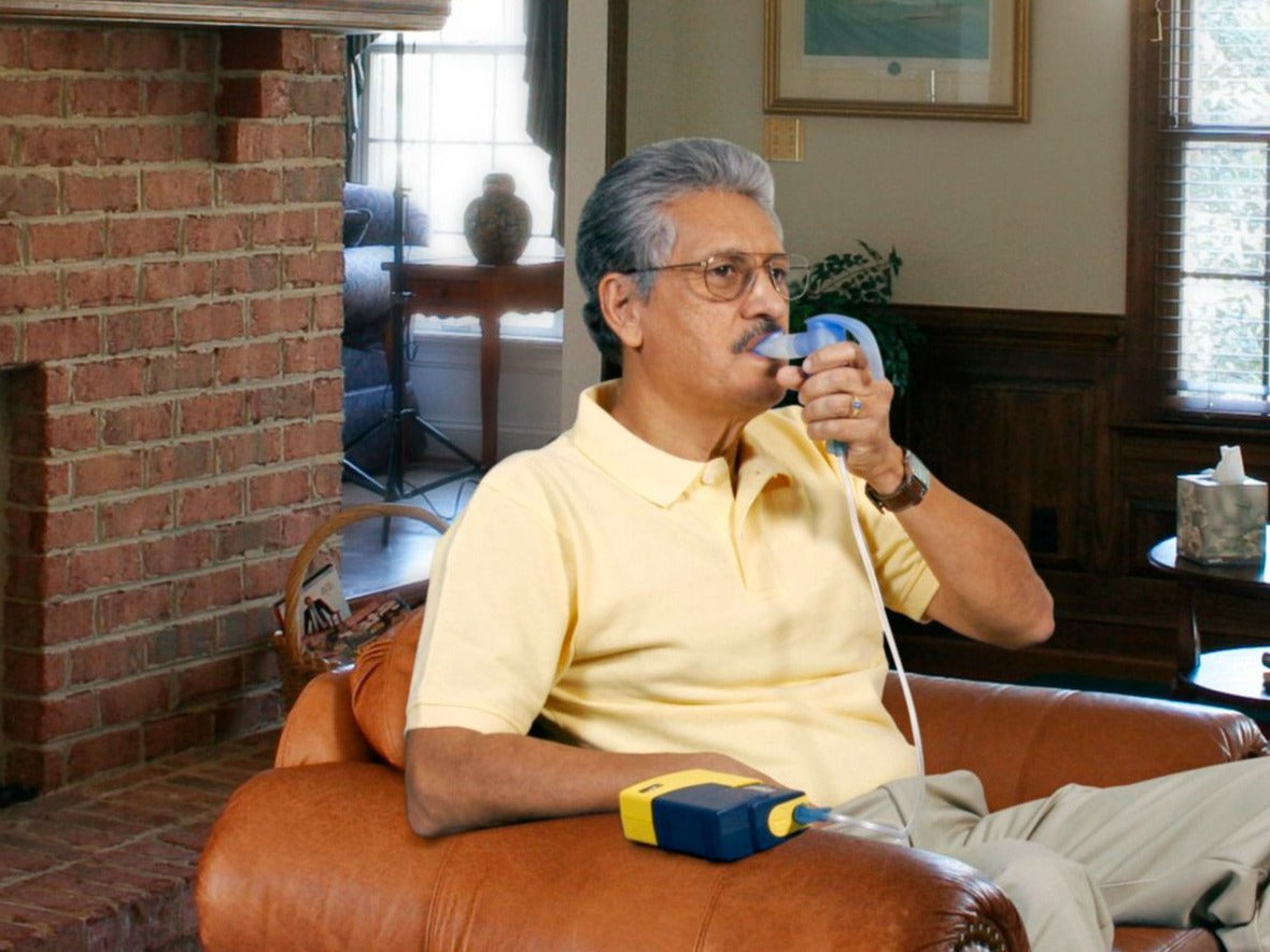 Adult using portable aerosol compressor.