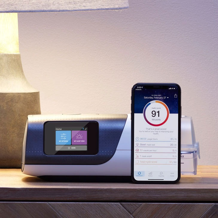 AirSense 11 on nightstand next to phone.