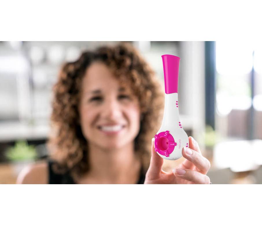 Woman holding the PN Medical The Breather Device.